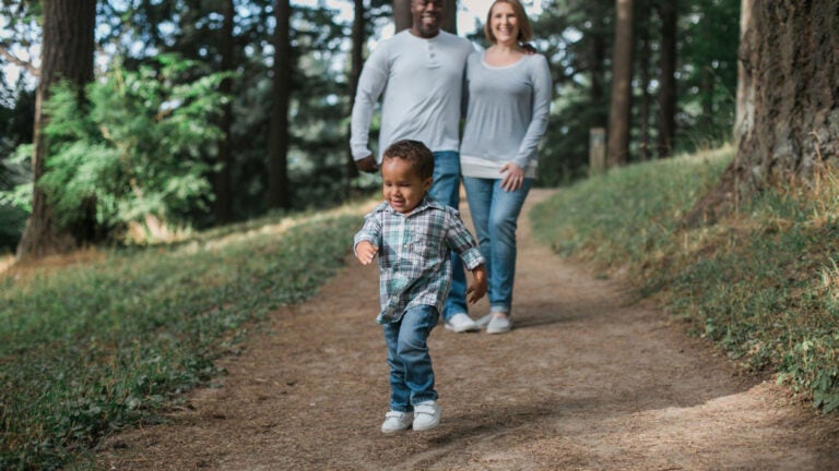 family walking in the woods